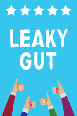 Writing note showing Leaky Gut. Business photo showcasing A condition in which the lining of small intestine is damaged Men women hands thumbs up approval five stars info blue background