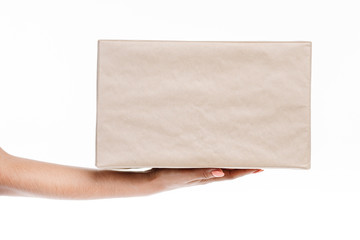 Close up shot of a big packed parcel held by someone's hand.