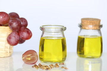 Grape seed oil in glass bottles on white background