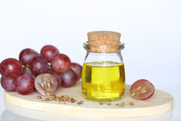 Grape seed oil in glass bottles on white background