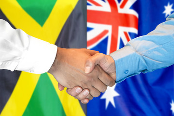 Business handshake on the background of two flags. Men handshake on the background of the Jamaica and Australia flag. Support concept