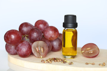 Grape seed oil in glass bottles on white background