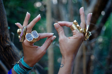 Rings of Power. Semi precious gemstone crystal rings displayed on the beautiful hands of a yoga ...