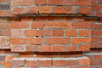Embossed textured surface of the old orange brick and cement wall