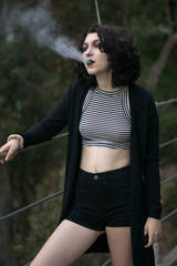 emo goth girl smoking on a bridge
