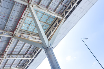 Roof support column made of iron, aluminum, glass and concrete. Modern architecture detail of international airport. Design and construction concept. Space for text.