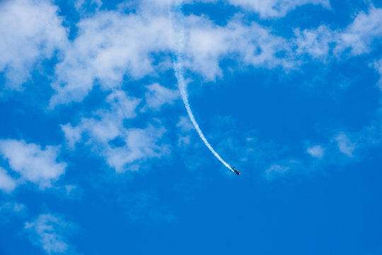 photo of blue sky with airplane on a cloudy summer day