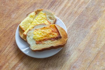 White plate with fried toasts with cheese