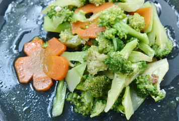 stir fried broccoli and carrot with slice pork in oyster sauce on plate