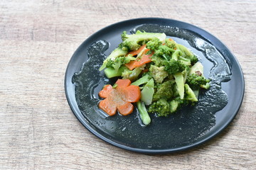 stir fried broccoli and carrot with slice pork in oyster sauce on plate