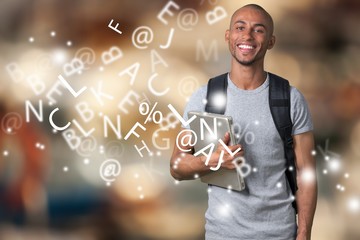 Smiling African Student man with laptop, mall background, bokeh