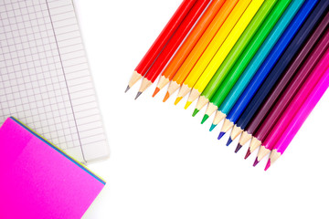 Color pencils, sticky memo and notebook on a white background. Back to school