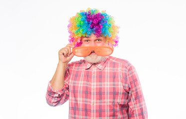 Circus show. Elderly clown. Man senior bearded cheerful person wear colorful rainbow wig. Grandpa always fun. Having fun. Funny lifestyle. Fun and entertainment. Comic happy grandfather concept