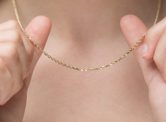 Woman Holding Gold Chain Necklace