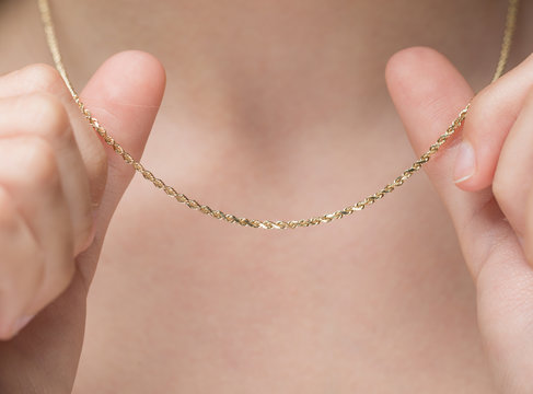 Woman Holding Gold Chain Necklace