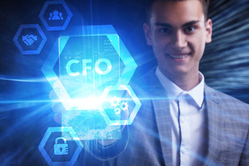 The concept of business, technology, the Internet and the network. A young entrepreneur working on a virtual screen of the future and sees the inscription: CFO