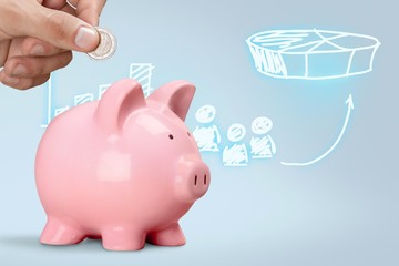 Man putting coin in pig moneybox