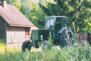 A tractor stands at a rural house