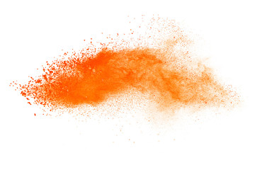 Abstract orange powder explosion. Closeup of orange dust particle splash isolated on white background