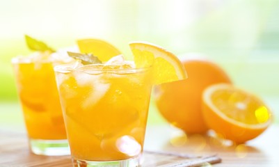 Close-up of fresh orange drinks on table background