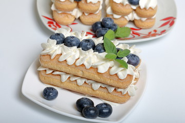 Cakes made from Italian savoyardi cookies and cream. Decorated with blueberries and mint leaves.
