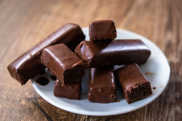 Chocolate cookies on a plate on old wooden table