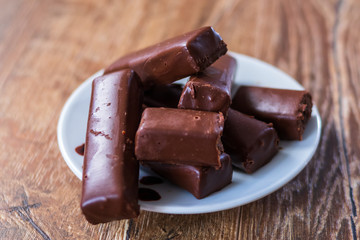 Chocolate cookies on a plate on old wooden table