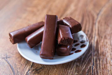 Chocolate cookies on a plate on old wooden table