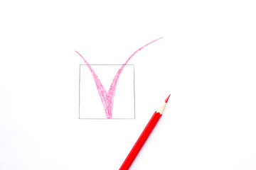 Red tick drawn  with pencil isolated on white background. Top view, flat lay composition