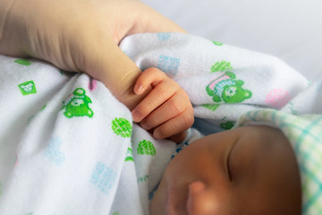 Newborn children's hand in mother hand. Mom and her Child. Happy Family concept.