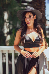 Tall mixed race woman in summer fashion poses outdoors