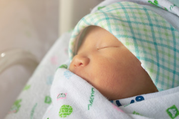 Asian newborn baby was wrapped in cloth after bathing