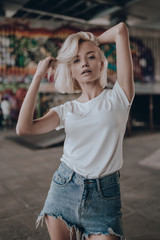 Stylish sexy attractive woman walking on urban background in summer day. Sexy pretty beauty young...