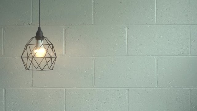 geometric lamp on blank cinder block wall