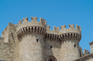 Fototapeta na wymiar Turrets of the Grand Palace in the old medieval part of Rhodes town in Greece