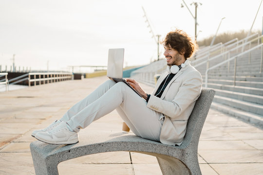Businessman working on laptop outdoors
