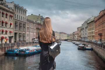 Fototapeta na wymiar A woman walks around St. Petersburg
