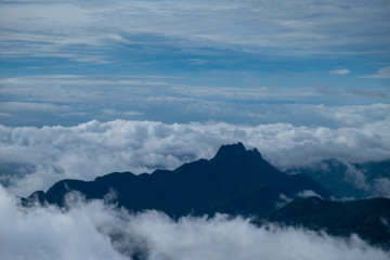 Foggy autumn landscape. Colorful fog and mountains on morning sky background. 