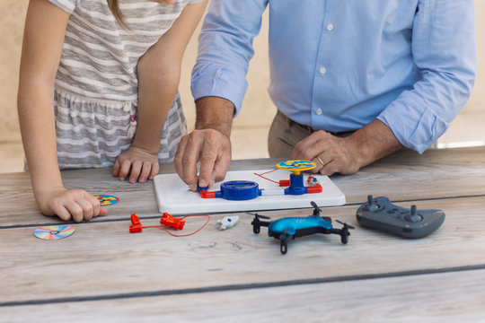 Father teaching his daughter electronics and robotics