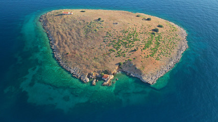 Aerial drone photo from picturesque islet of Agios Georgios featurinf small chapel, Galaxidi village, Greece