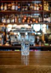 Abstract empty whisky glass, color background