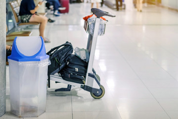 Blue cover transparent trashcan for increasing safety measures placed on the floor in the airport.