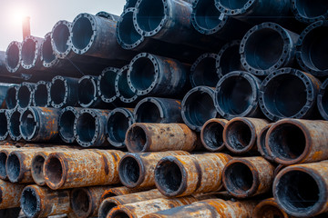 Drill pipe of  oil drilling platforms. Stack of oil well casing bundles at the pin end of casing. Downhole drilling rig