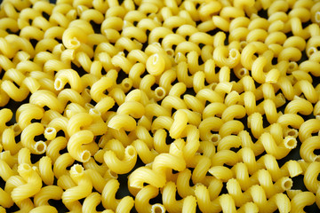 Spiral pasta cavatappi close up background