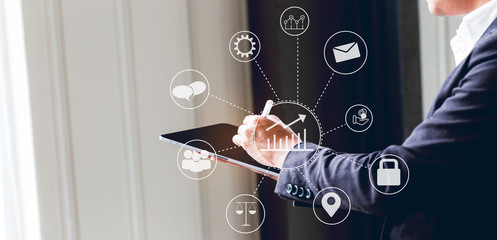 Asian business man using digital tablet in office to operate the network, e commerce online at the office, The media reaches the operational guidelines, for panoramic banner background with copy space