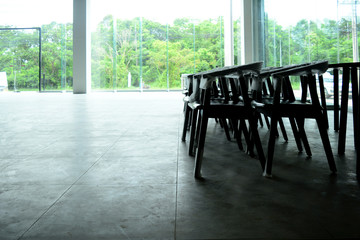 The empty  showroom after renovate with wooden chairs and tables with white bright light from outside