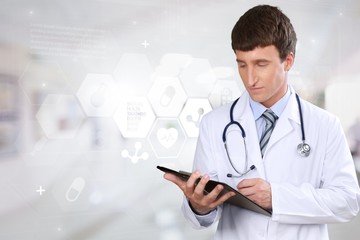 Handsome doctor with stethoscope smiling at camera