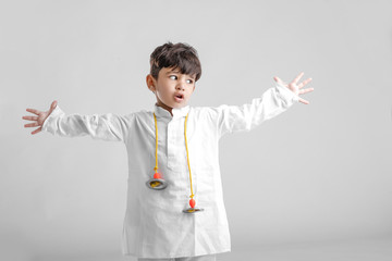 Indian Little Boy in Traditional Dress and learning with Musical instrument 