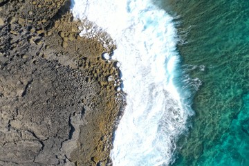 Aerial view to ocean waves and coast