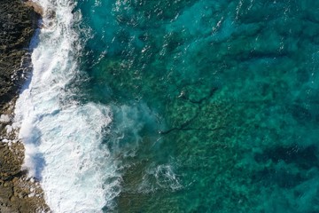 Aerial view to ocean waves and coast